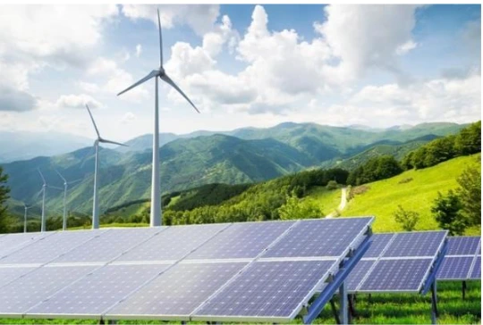 solar panels and wind turbines in a grassy area for renewable energy