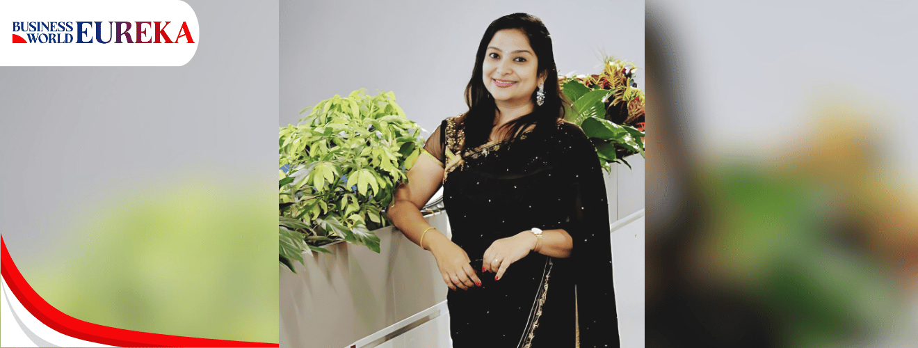 Srividhya Deshpande posing confidently in a black saree next to indoor plants, featured in Business World Eureka.